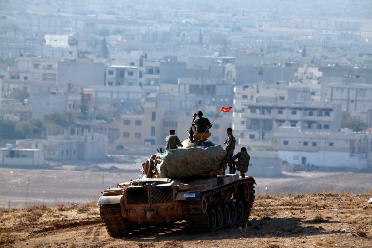 Turkish soldiers on a tank hold their position on a hilltop on the outskirts of Suruc, at the Turkey-Syria border, overlooking Kobani, Syria, during fighting between Syrian Kurds and the militants of Islamic State group, Thursday, Oct. 9, 2014. The fighting over Kobani has brought Syria's civil war yet again to Turkey's doorstep and allies have tried to press Ankara to take a more robust role in the U.S.-led coalition to fight the Islamic State group. (AP Photo/Lefteris Pitarakis)