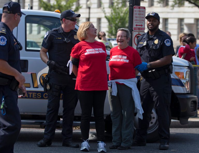   Women are arrested as they block the intersection of Independence Avenue SE and New Jersey Avenue SE outside the House of Representatives on Capitol Hill in Washington, Thursday, Sept 12, 2013, to protest Congress' inaction on comprehensive and inclusive immigration reform. (AP Photo/Carolyn Kaster)  