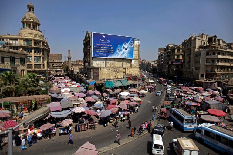 Egyptians crowd a market in Cairo last month. (AP/Khalil Hamra)

