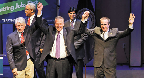 Virginia Attorney General Mark Herring, left, opened the door for kids ofÃÂ immigrants to receive in-state tuition rates. He is shown with Gov. Terry McAuliffe and Lt. Gov. Ralph NorthamÃÂ during last year'sÃÂ election. (AP Photo/Steve Helber)
