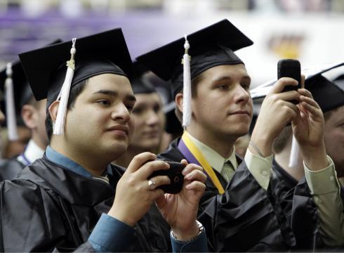 Graduates look on as first lady Michelle Obama gives the commencement address at the University of Northern Iowa graduation on May 7, 2011in Cedar Falls, Iowa. AP Photo.