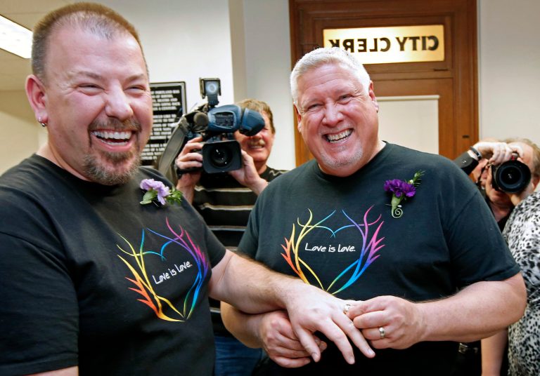   Steven Bridges, left, receives a wedding ring from Michael Snell, early Saturday, Dec. 29, 2012, at City Hall in Portland, Maine. Same-sex couples in Maine are now legally allowed to marry under a new law that went into effect at 12:01 a.m. on Saturday. (AP Photo/Robert F. Bukaty)  