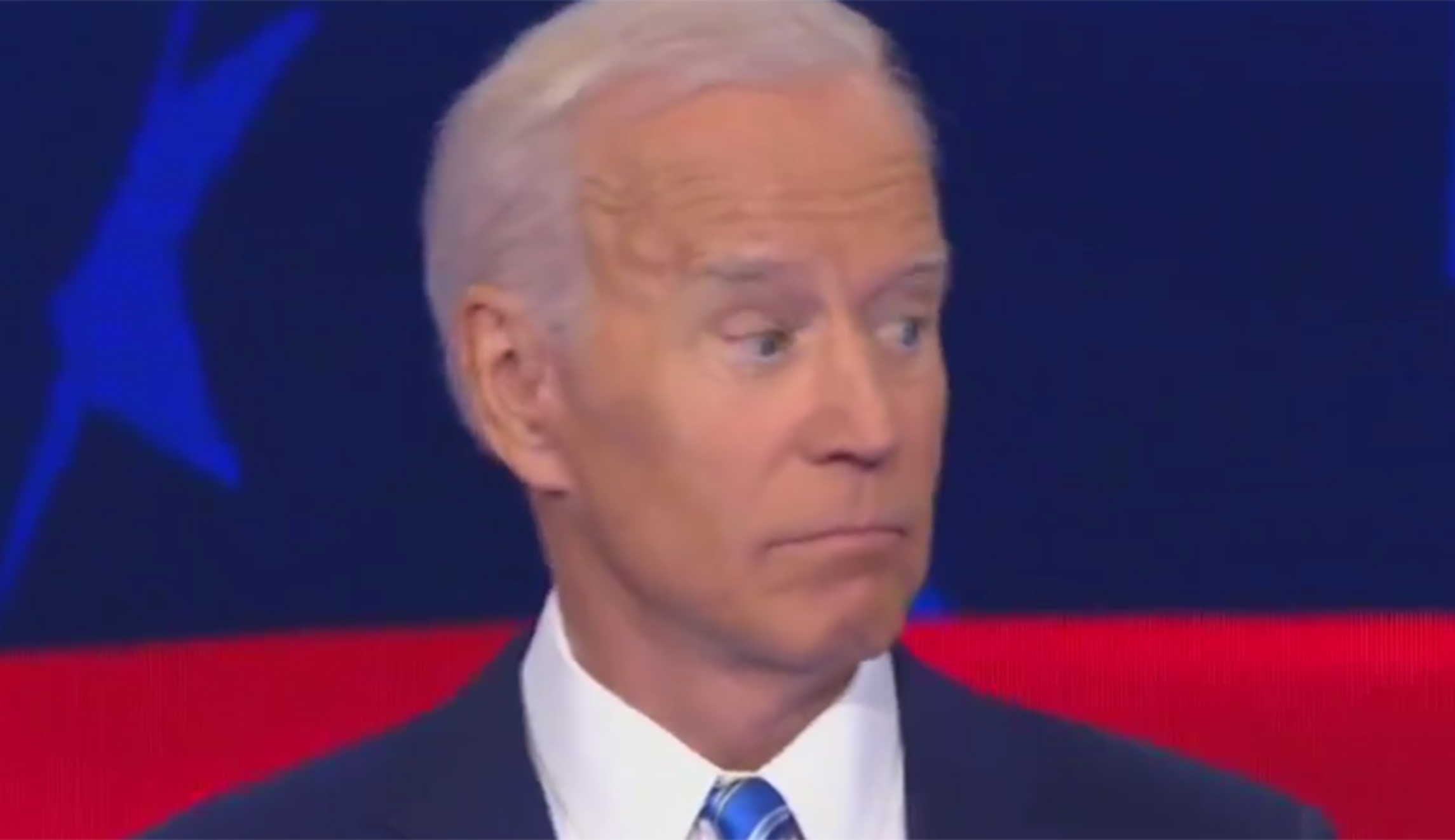 Waving hand of Bernie Sanders startles Joe Biden