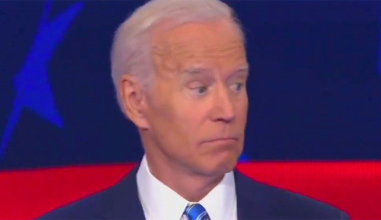 Waving hand of Bernie Sanders startles Joe Biden