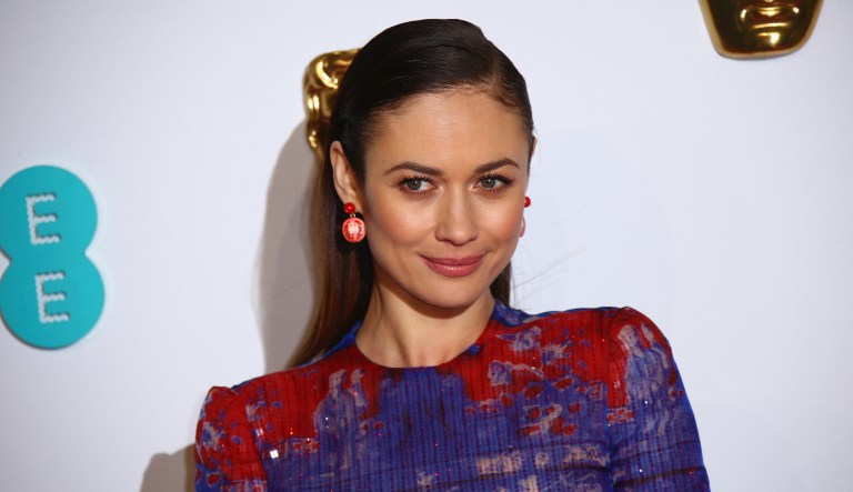 Actress Olga Kurylenko poses for photographers upon arrival at the BAFTA awards in London, Sunday, Feb. 10, 2019.