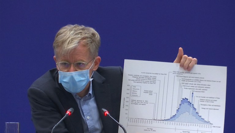 Bruce Aylward, an assistant director-general of the World Health Organization speaks with a chart during a press conference in Beijing on Monday, Feb. 24, 2020. 