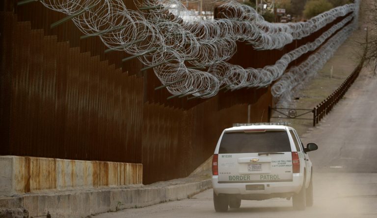 A Customs and Border Control agent patrols on the U.S. side of a razor-wire-covered border wall that separates Nogales, Mexico, from Nogales, Ariz. Saturday, March 2, 2019. 