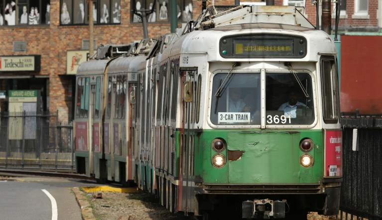 In this Thursday, June 18, 2015 photo, a Massachusetts Bay Transportation Authority train makes it's way along a curved portion of track, in Boston. Public transportation has long been hailed as a surefire remedy for traffic congestion, but many of the nation's largest mass transit systems are struggling.