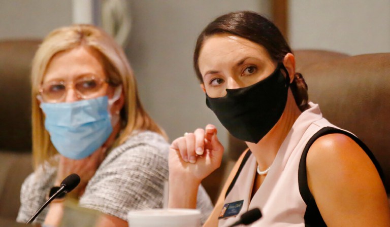 Norman Mayor Breea Clark, right, listens during a city council meeting Tuesday, June 9, 2020 in Norman, Okla. An effort to recall Clark and some council members is underway. (AP Photo/Sue Ogrocki)