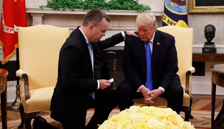 President Donald Trump prays with American pastor Andrew Brunson in the Oval Office of the White House, Saturday, Oct. 13, 2018, in Washington. Brunson returned to the U.S. around midday after he was freed Friday, from nearly two years of detention in Turkey.