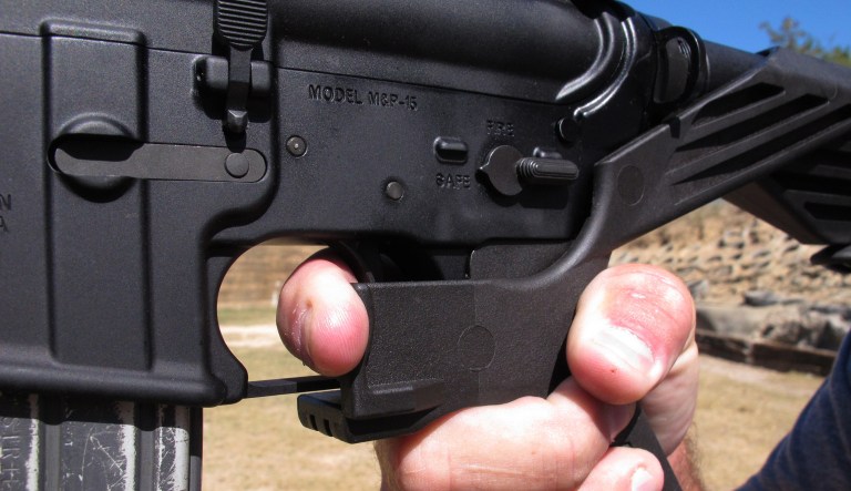 Shooting instructor Frankie McRae illustrates the grip on an AR-15 rifle fitted with a "bump stock" at his 37 PSR Gun Club in Bunnlevel, N.C., on Wednesday, Oct. 4, 2017. The stock uses the recoil of the semiautomatic rifle to let the finger "bump" the trigger, making it different from a fully automatic machine gun, which are illegal for most civilians to own.
