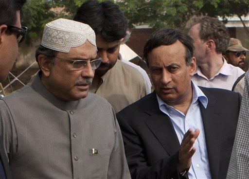 In this picture taken on August 19, 2010 shows Pakistan's Ambassador in Washington Hussain Haqqani, right, talks with Pakistan's President Asif Ali Zardari in Multan, Pakistan. Pakistan's envoy to the United States says he has resigned over claims he wrote a memo to Washington asking for its help in reining in the country's powerful military.