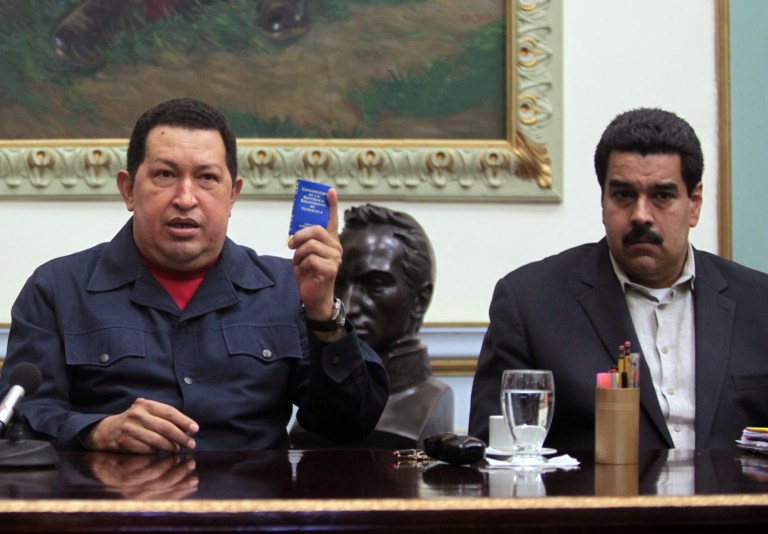   FILE - In this Dec. 8, 2012, file photo released by Miraflores Press Office, Venezuela's President Hugo Chavez, left, holds up a copy of the Venezuelan national constitution as his Vice President Nicolas Maduro looks on during a televised speech at Miraflores presidential palace in Caracas, Venezuela. Chavez has suffered 