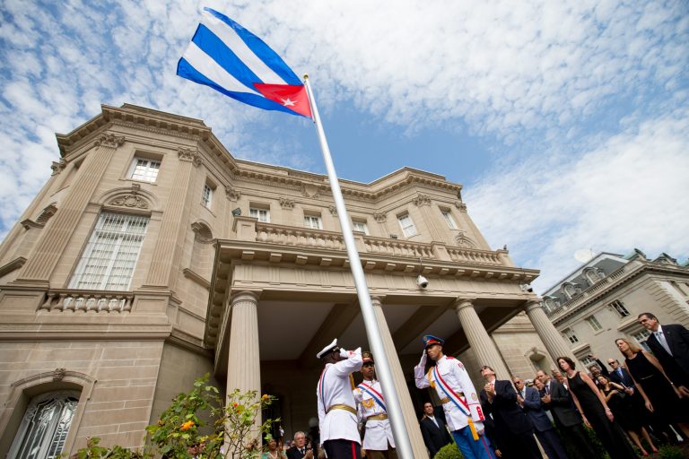 Cuban Foreign Minister Bruno Rodriguez, right of center, applauds with other dignitaries after raising the Cuban flag over their new embassy in Washington, Monday, July 20, 2015. (AP Photo)Â 
