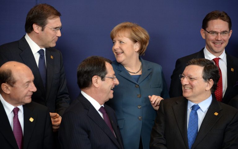FILE - In this Thursday, Dec. 19, 2013 file photo, German Chancellor Angela Merkel, center rear, speaks with other EU heads of state during an EU summit in Brussels. As chancellor of Germany Angela Merkel may be the most powerful politician in the European Union, but she is more mirage than reality when it gets to the place of women in EU politics. EU leaders meet on Saturday to divide top jobs for the next five years, and after years of paying lip service to more equality among the sexes, it is plain for all to see, where are the women? (AP Photo/Geert Vanden Wijngaert, File )