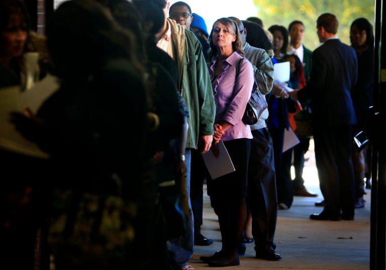 FILE - In this Nov. 7, 2013 file photo, Jona Caldwell joins a long line of job seekers outside the Ferguson Community Center in Cordova, Tenn. The Labor Department reports on the number of Americans who applied for unemployment benefits in the last week on Dec. 26, 2013. (AP Photo/The Commercial Appeal, Jim Weber, File)
