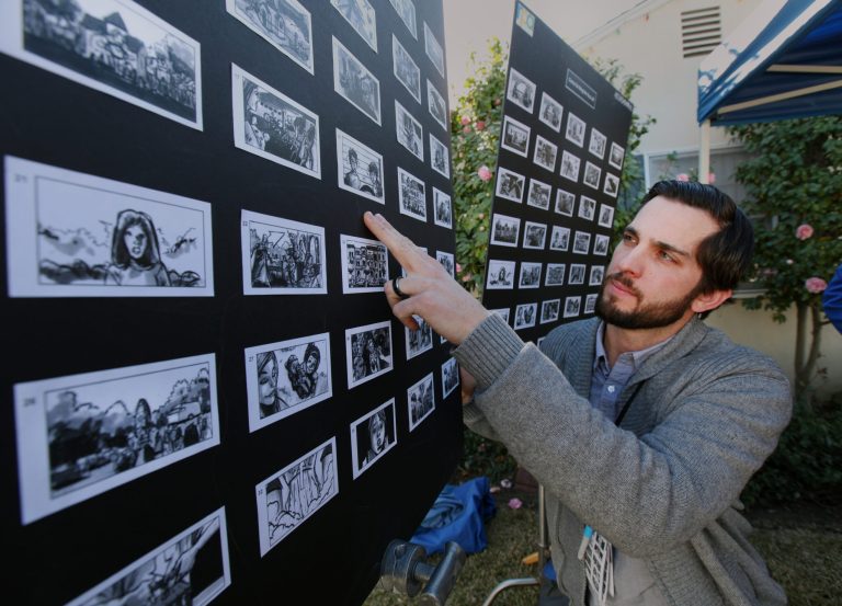 In this photo taken Jan. 13, 2014, Nathan Crow, Creative Director at RPA: Rubin Postaer and Associates, an advertisement agency, checks a story board before a film crew films a commercial for Goldie Blox, a small business who was awarded the Intuit Small Business Big Game to be highlighted during the 2014 Super Bowl in Pasadena, Calif. Intuit, with the help of the public, selected Goldie Blox: Engineering Toys for Girls. (AP Photo/Nick Ut)