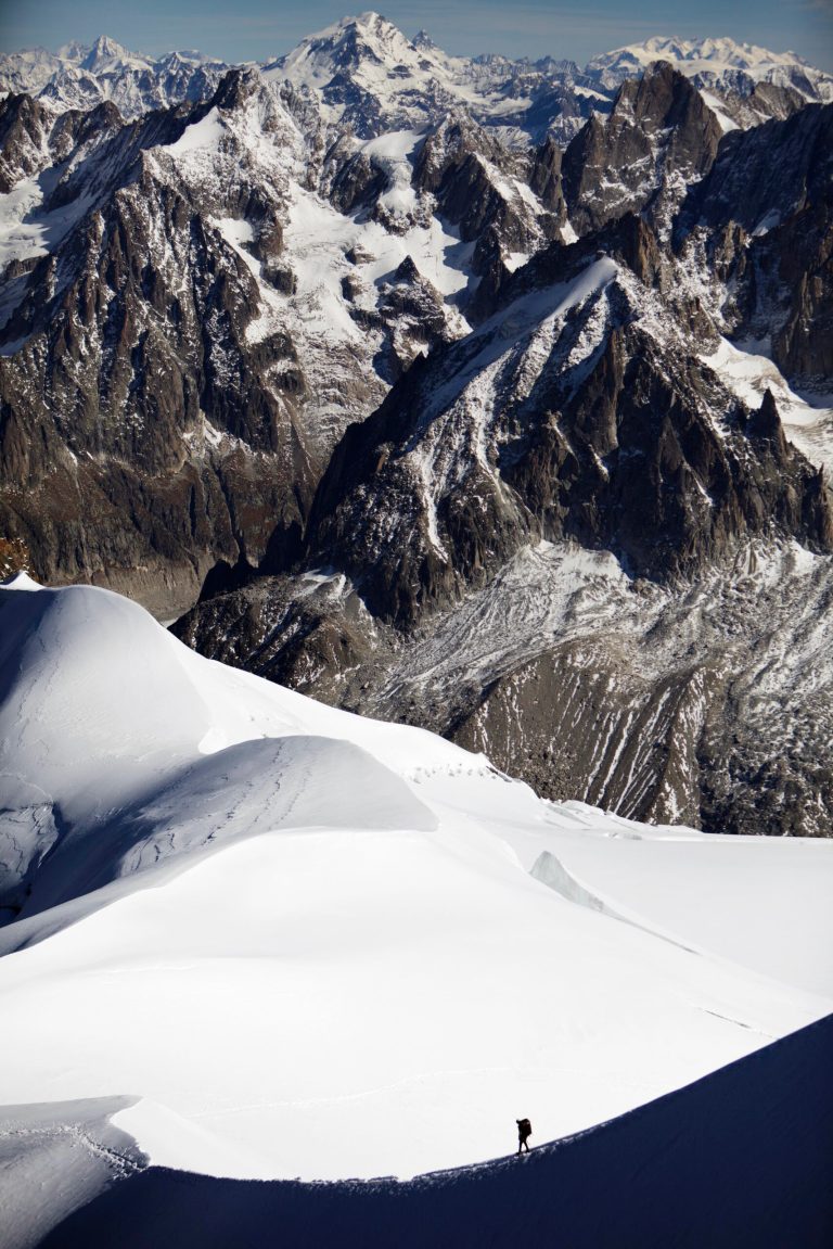 FILE - In this file photo dated Wednesday, Oct. 12, 2011, an alpinist heads down a ridge on the Aiguille du Midi (3,842 meters; 12 605 feet), towards the Vallee Blanche on the Mont Blanc massif, in the Alps, near Chamonix, France. The mayor of the French city of Chamonix says two climbers and an experienced guide have died in a fall accident in the Aiguille de Midi area of the Mont Blanc massif and their bodies were recovered Sunday Aug. 17, 2014. These latest deaths come less than a week after six climbers, including an experienced guide, were killed in a fall. (AP Photo/David Azia, FILE)