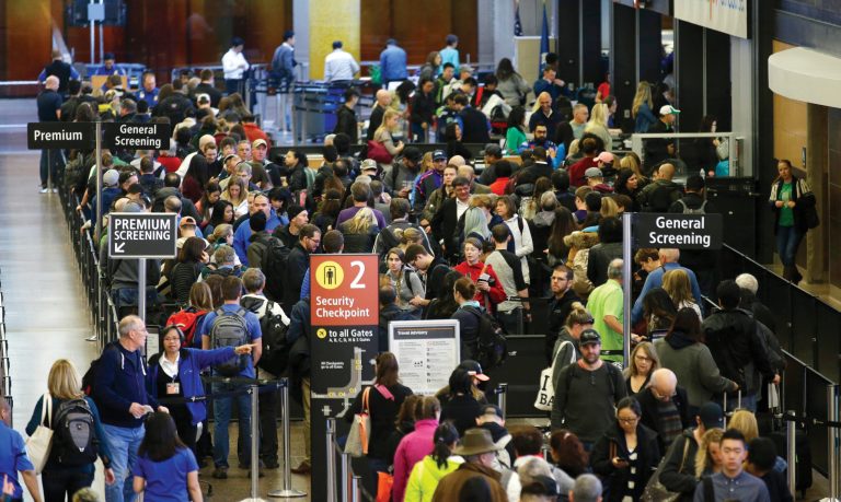 Travelers wait in line for security screening at Seattle-Tacoma International Airport. Fliers will likely face massive security lines at airports across the country this summer, with airlines already warning passengers to arrive at least two hours early or risk missing their flight. (AP Photo/Ted S. Warren)