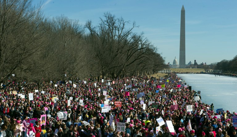 The Capitol and Washington Monument are seen as Women's March demonstrators line the Reflecting Pool at the Lincoln Memorial in Washington, Saturday, Jan. 20, 2018. President Trump sent his regards to the marchers in a tweet on Saturday. (AP Photo/Cliff Owen)