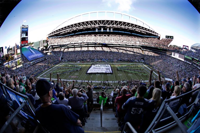 FILE - In this Thursday, Sept.  4, 2014, file photo, a giant Super Bowl championship banner is unfurled on the field before an NFL football game between the Seattle Seahawks and Green Bay Packers in Seattle. The Nielsen company said Tuesday, Sept. 9, 2014,  that Thursday's kickoff game between Seattle and Green Bay was up 7 percent over the corresponding opening game a year ago, while the inaugural Sunday night matchup of Indianapolis and Denver was down 7 percent from 2013. (AP Photo/Scott Eklund, File)