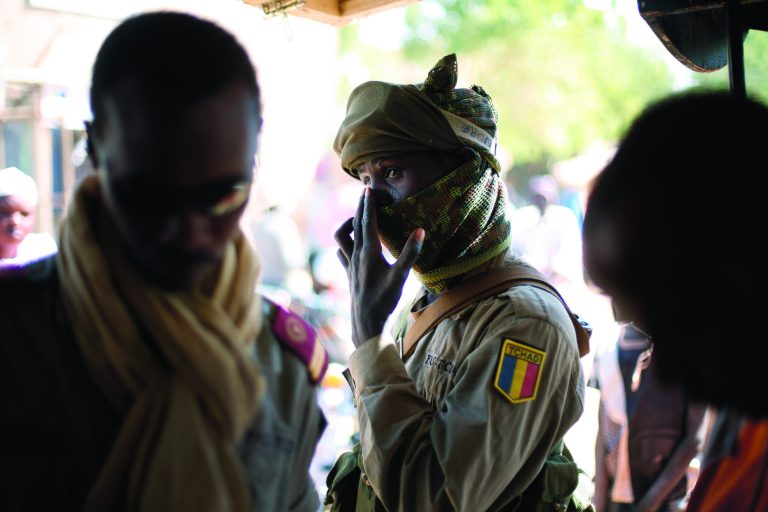 A Chadian soldier shops in the central market in Gao, Northern Mali, Wednesday Jan. 30, 2013. The mission by French troops scored another success in its effort to dislodge the al-Qaida-linked militants from northern Mali, and freed from Islamic rule over the weekend, women started coming out wearing bright colors, makeup and jewels, after 10-month of black veils and sharia laws. (AP Photo/Jerome Delay)