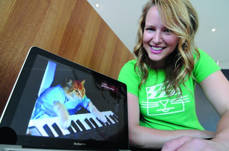 Katie Hill, a program associate with the Walker Art Center, shows a frame from a cat video of a cat playing the piano Wednesday, Aug. 29, 2012, in Minneapolis. The Walker will present its first 