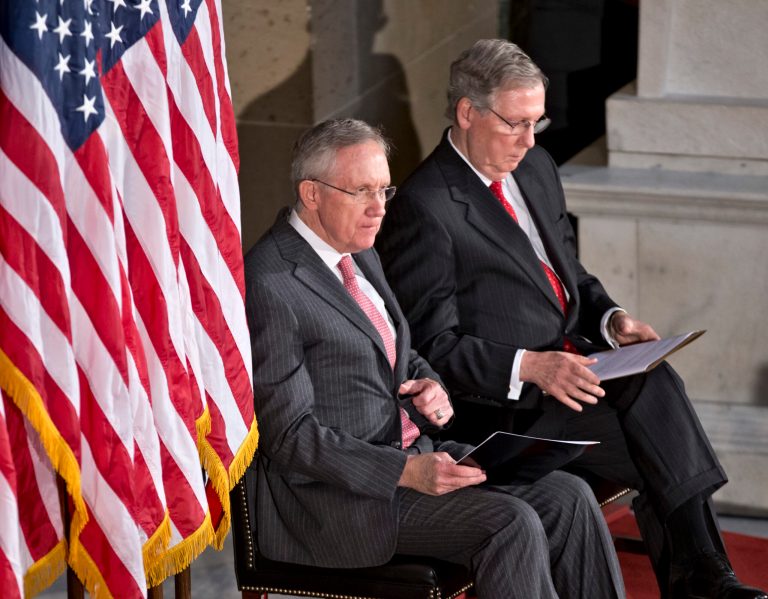 The Senate's top Democrat, Majority Leader Harry Reid, D-Nev., center, and the top Republican, Minority Leader Mitch McConnell, R-Ky., right, sit together during a ceremony at the Capitol in Washington, Wednesday, July 31, 2013. (AP Photo/J. Scott Applewhite)