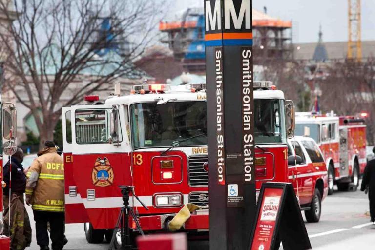 Emergency crews assist Metro riders stuck near the Smithsonian station on Tuesday. 