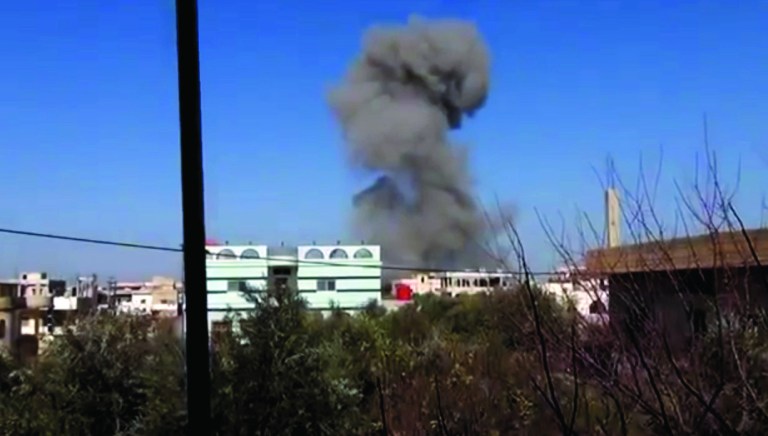 In this image taken from video obtained from the Ugarit News, which has been authenticated based on its contents and other AP reporting, smoke rises after an airstrike hit Daraa, Syria, on Monday, Jan. 14, 2012. (AP Photo/Ugarit News via AP video)