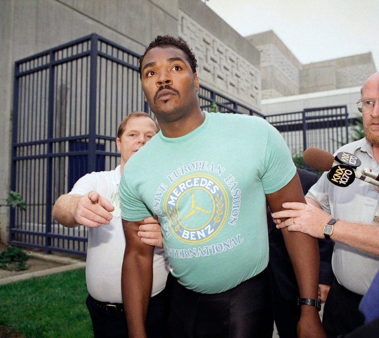   FILE - This July 16, 1992 file photo shows Rodney King being escorted from jail in Santa Ana, Calif. after he was arrested for investigation of drunken driving. King, whose videotaped beating by police in 1991 led to LA race riots, has died at 47. (AP Photo/Kevork Djansezian, file)  