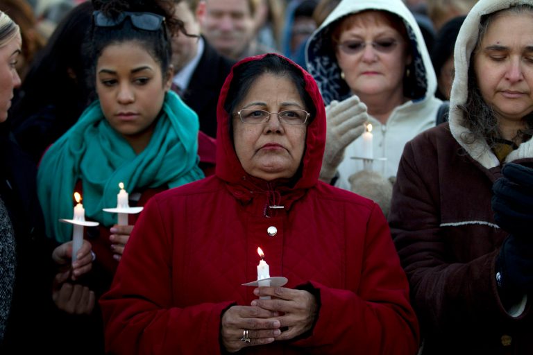 People gather for a candlelight vigil outside the Mall in Columbia, Md, in memory of shooting victims Brianna Benlolo and Tyler Johnson, on Thursday Jan. 30, 2014. Three people died Saturday in a shooting at a mall in suburban Baltimore, including the presumed gunman. ( AP Photo/Jose Luis Magana)