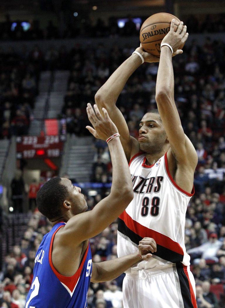   Portland Trail Blazers forward Nicolas Batum, right, from France, looks to pass inside against Philadelphia 76ers guard Evan Turner during the second half of an NBA basketball game in Portland, Ore., Saturday, Dec. 29, 2012. Batum led the Trail Blazers with 22 points as they defeated the 76ers 89-85.(AP Photo/Don Ryan)  