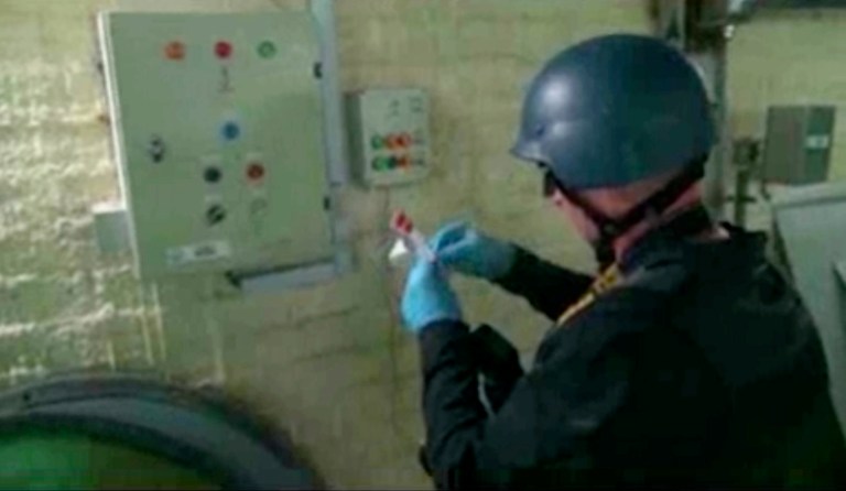 This file image made from video broadcast on Syrian State Television on Tuesday, Oct. 8, 2013 purports to show a chemical weapons expert taking samples at a chemical weapons plant at an unknown location in Syria. (AP File)