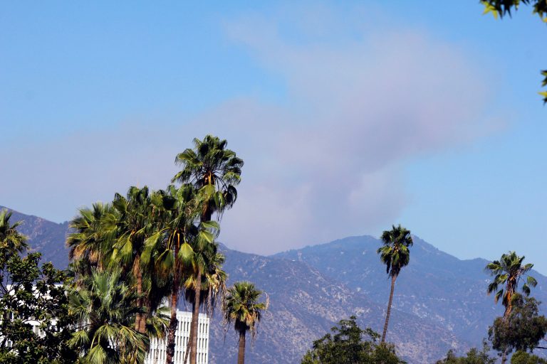 Smoke from a wildfire rises above the San Gabriel Mountains above Azusa, Calif., Sunday, Aug. 17, 2014. A wildfire in the Angeles National Forest in Southern California is forcing people to evacuate from a campground and recreational areas. U.S. Forest Service spokesman Nathan Judy says the fire above the foothill community of Azusa was reported about 2:30 p.m. Sunday. (AP Photo/John Antczak)