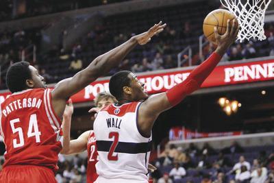 Jacquelyn Martin/AP
Wizards point guard John Wall had a career-high 38 points to go along with eight assists in Monday's loss to the Rockets.