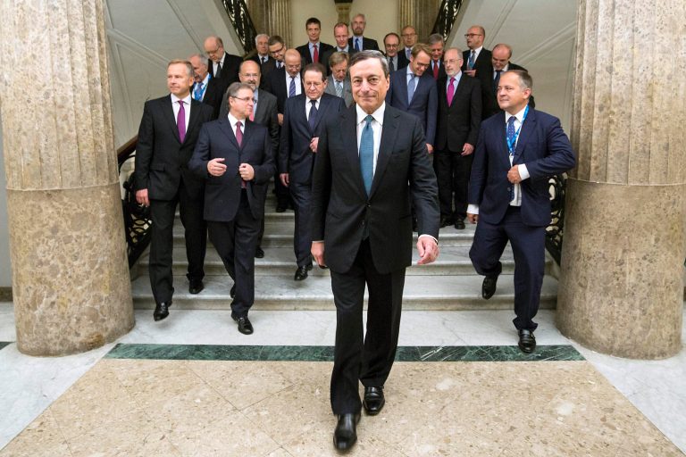 President of European Central Bank Mario Draghi walks in front of the ECB governing council prior to their meeting in Naples, Italy, Thursday, Oct. 2, 2014. European Central Bank head Mario Draghi is expected Thursday to underline the bank's willingness to deploy more economic stimulus measures, a stance that could send the euro skidding even lower. And a drop in the currency which helps eurozone exporters and could nudge up worryingly low inflation might be the most effective stimulus to come out of the ECB's monthly meeting. (AP Photo/Lapresse, POOL)
