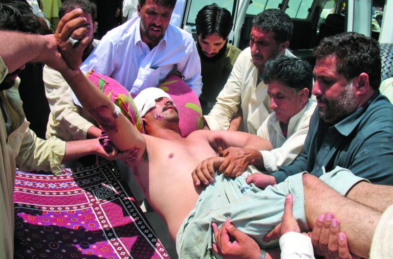 A man who was injured in a roadside bomb in Kohat district outside Orakzai, is brought to a hospital in Peshawar, Pakistan, Wednesday, July 18, 2012. A minibus carrying minority Shiite Muslims hit an anti-tank land mine in northwestern Pakistan on Wednesday, killing several of them in what police described as the country's latest sectarian attack. (AP Photo/Mohammad Zubair)