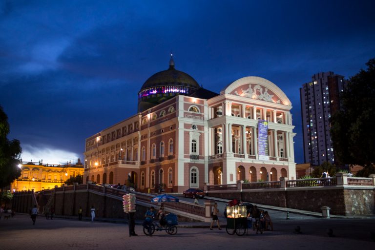 This May 20, 2014 photo, the Teatro Amazonas is seen as dusk in Manaus, Brazil. The theater is the symbol of Manaus, a city carved out of the rainforest, still so remote it can only be reached by plane or boat even though it has grown to over 2 million inhabitants. (AP Photo/Felipe Dana)