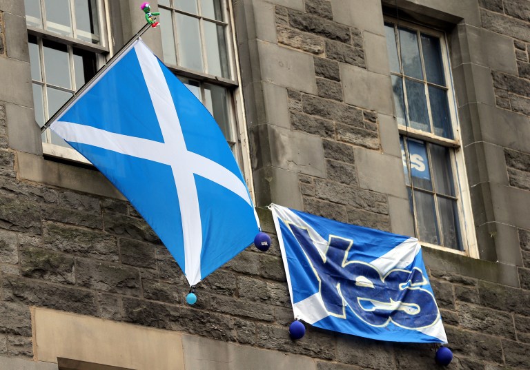 A Saltire flag and a Yes sign are displayed from an apartment in Edinburgh, Scotland, on Tuesday. (AP/Scott Heppell)