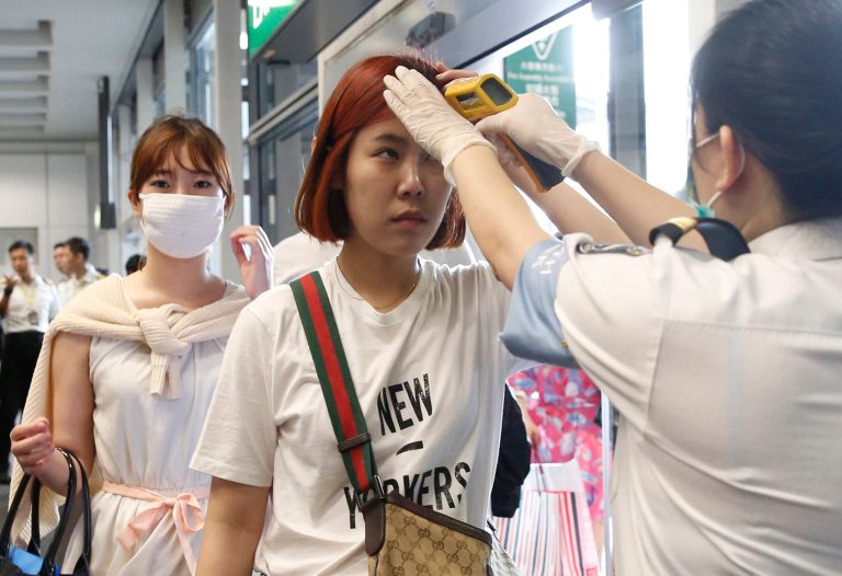 Passengers flying from Busan, South Korea, receive temperature checks for MERS (Middle East Respiratory Syndrome) as they arrive at Hong Kong Airport, Friday, June 5, 2015. The current frenzy in South Korea over MERS brings to mind the other menacing diseases to hit Asia over the last decade -- SARS, which killed hundreds, and bird flu. (AP Photo/Kin Cheung)