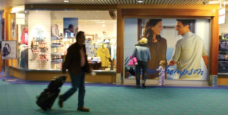 In this 2006 photo, airport passengers pass by Norm Thompson retail outlet at Portland International Airport in Portland. The Federal Trade Commission announced this week that two companies have agreed to refund $1.5 million to consumers who purchased 