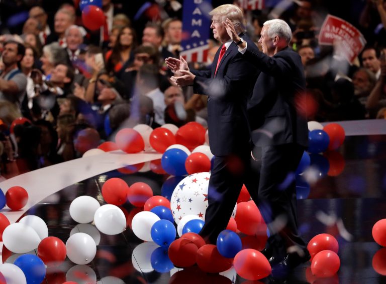 Republican presidential candidate Donald Trump, center left, walks with vice presidential candidate Gov. Mike Pence of Indiana as confetti and balloons fall during celebrations after Trump's acceptance speech on the final day of the Republican National Convention in Cleveland, Thursday, July 21, 2016. (AP Photo/Matt Rourke)