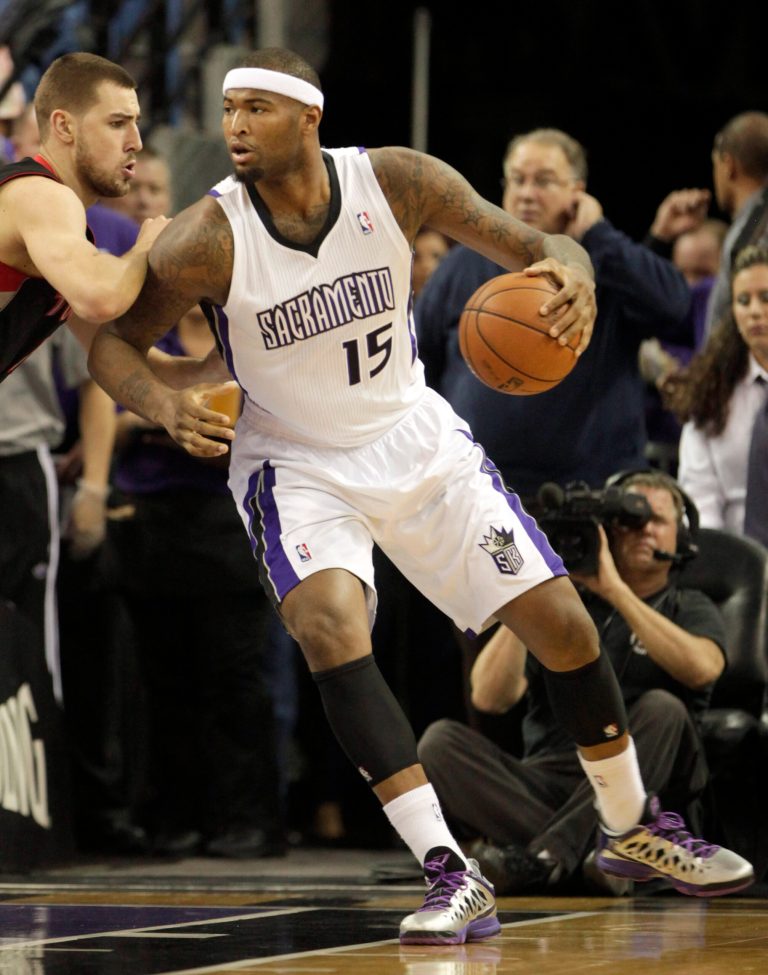   Sacramento Kings center DeMarcus Cousins, right, goes to the basket against Toronto Raptors center Jonas Valanciunas, of Lithuania, during the first quarter of an NBA basketball game in Sacramento, Calif., Wednesday, Dec. 5, 2012. (AP Photo/Rich Pedroncelli)  