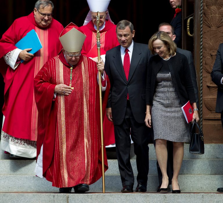 Bishop of Arlington, Rev. Paul Loverde, talks with U.S. Supreme Court Chief Justice John Roberts, center, and his wife Jane Marie, as they leave the Cathedral of St. Matthew the Apostle after the annual Red Mass for Supreme Court justices in Washington, Sunday, Oct. 5, 2014. The new Supreme Court term starts Monday. (AP Photo/Jose Luis Magana)