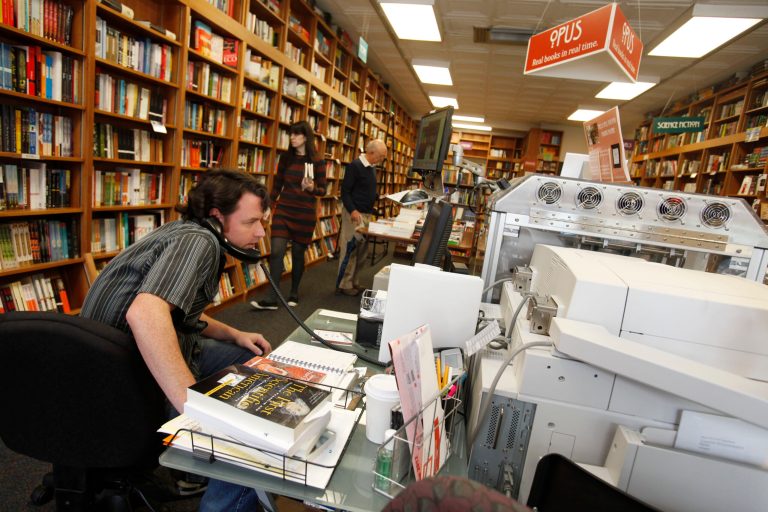   In this June 5, 2012, photo, Bill Leggett works on the Espresso Book Machine, known as Opus, at Politics and Prose bookstore in Washington. Self-publishing has been made easier since the macine by On Demand Books debuted in 2006. The machine also can makes copies of out-of-print editions. The first machine was installed briefly at the World Bankâs bookstore. Through a partnership with Xerox, the company now has machines in about 70 bookstores and libraries across the world including London; Tokyo; Amsterdam; Abu Dhabi, United Arab Emirates; Melbourne, Australia; and Alexandria, Egypt. (AP Photo/Jacquelyn Martin)  
