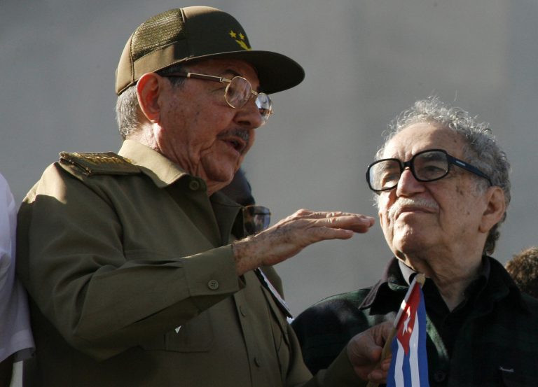FILE - In this Dec. 2, 2006 file photo, Cuba's acting President Raul Castro, brother of Cuban leader Fidel Castro, left, chats with Colombian Nobel laureate Gabriel Garcia Marquez during a military parade in Havana, Cuba. Marquez died on Thursday, April 17, 2014 at his home in Mexico City. (AP Photo/ Javier Galeano, File)
