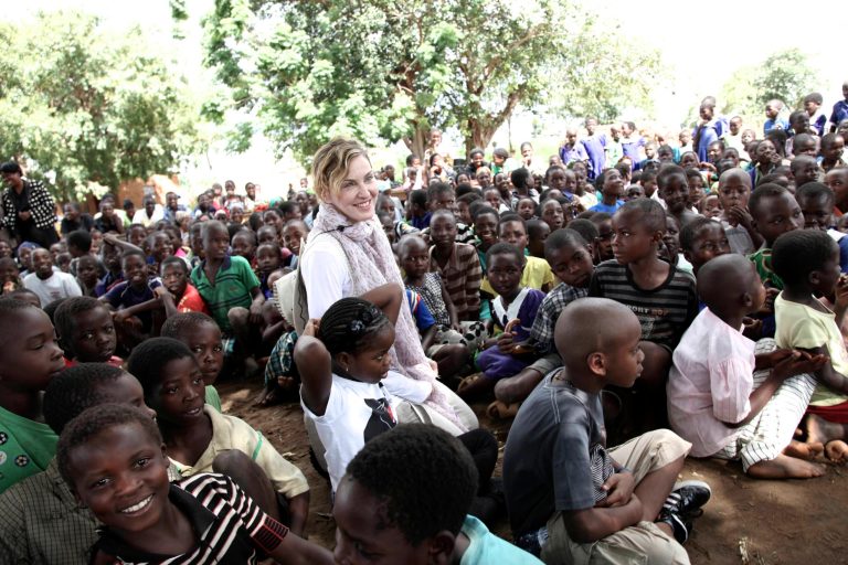 This image released by Liz Rosenberg Media shows singer Madonna visiting school children in Chorwe, Malawi on Wednesday, April 3, 2013. Madonna's foundation, Raising Malawi, has built ten schools in partnership with BuildOn which are currently educating over 4,000 students per year. (AP Photo/Liz Rosenberg Media)