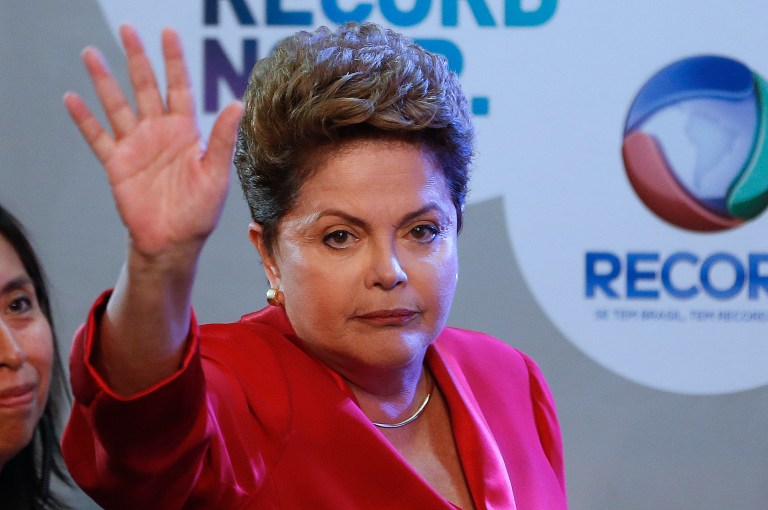 Brazil's President Dilma Rousseff, presidential candidate for re-election of the Workers Party (PT), gestures to journalists prior to a televised presidential debate in Sao Paulo, Brazil, Sunday, Sept. 28, 2014. Brazil will hold general elections on Oct. 5. (AP Photo/Andre Penner)
