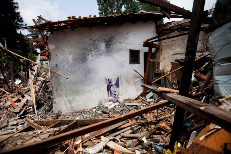 A destroyed house that was hit by a rocket fired by Palestinians militants from Gaza, in Yahud, a Tel Aviv suburb near the airport, central Israel, Tuesday. As a result, Delta Air Lines and U.S. Airlines decided to cancel their scheduled flights to Israel. (AP Photo/Dan Balilty)